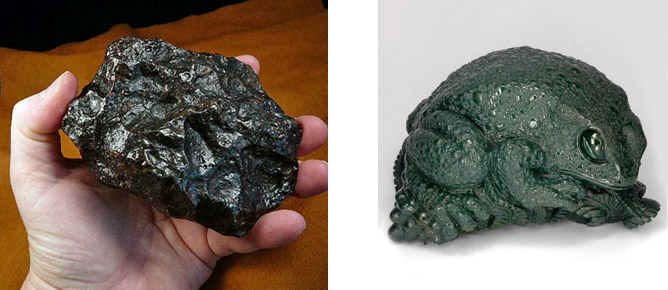 A greasy-looking black meteorite and a bloodstone toad statue of malignant aspect 